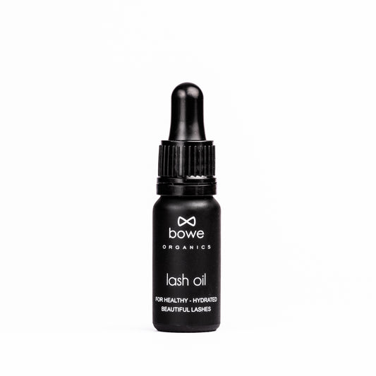 Bowe Organics Lash Oil photographed on a white background. the vegan lash treatment oil is in a matt black glass bottle with a black rubber and plastic pipette. the label reads 'bowe organics lash oil for healthy, hydrated beautiful lashes'