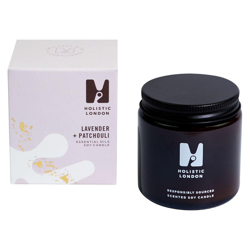 photograph of holistic london's lavender and patchouli 120g soy based candle on a white background. on the left side of the image is the light purple cardboard box with the holistic london logo on it. the label reads ' lavender and patchouli essential oils soy candle'. on the right side of the photo is the amber jar with a black aluminium lid which holds the candle. the glass is printed with the holistic london logo and says 'responsibly sourced scented soy candle'
