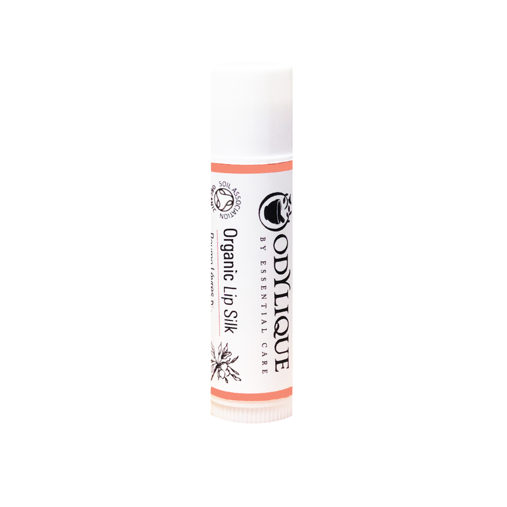 A white tube of the Odylique Organic Lip silk, set against a plain white background.