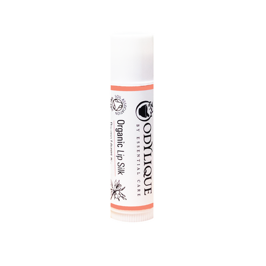 A white tube of the Odylique Organic Lip silk, set against a plain white background.