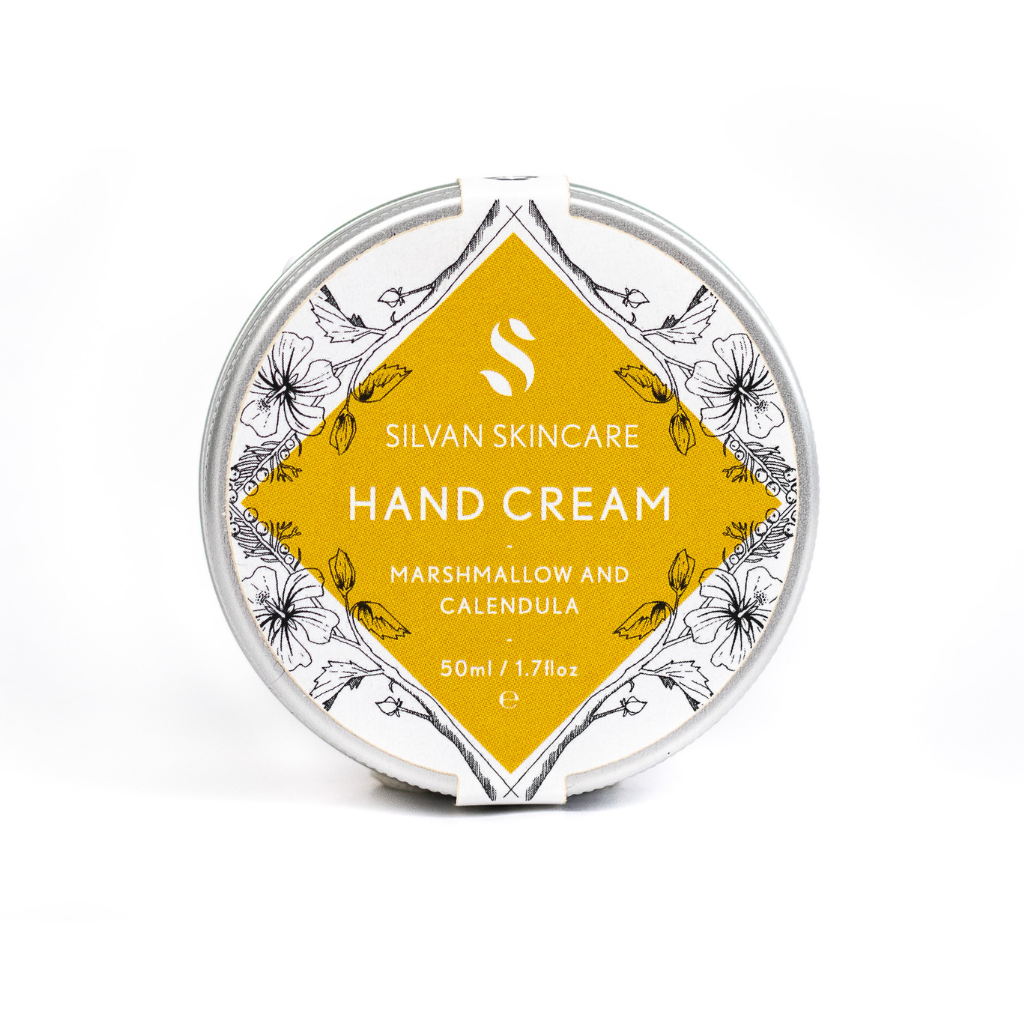 Silvan Skincare Hand Cream in the Hands and Feet Gift Set. Cruelty free gifts. The tin of hand cream is sitting on its side with the yellow label straight up.