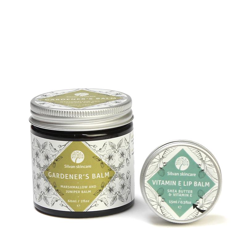 Silvan Skincare Gardener's Gift Set. Natural skincare gifts featuring a vegan and natural balm suitable for hard working hands and a fragrance free gentle lip balm in a silver aluminium tin with a white label and light teal green diamond feature 