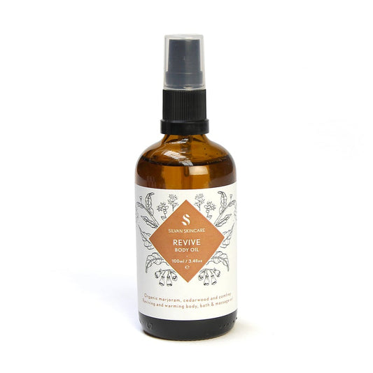 Silvan Revive Body Oil in an amber glass bottle with a white label against a white background. Natural Body Oil