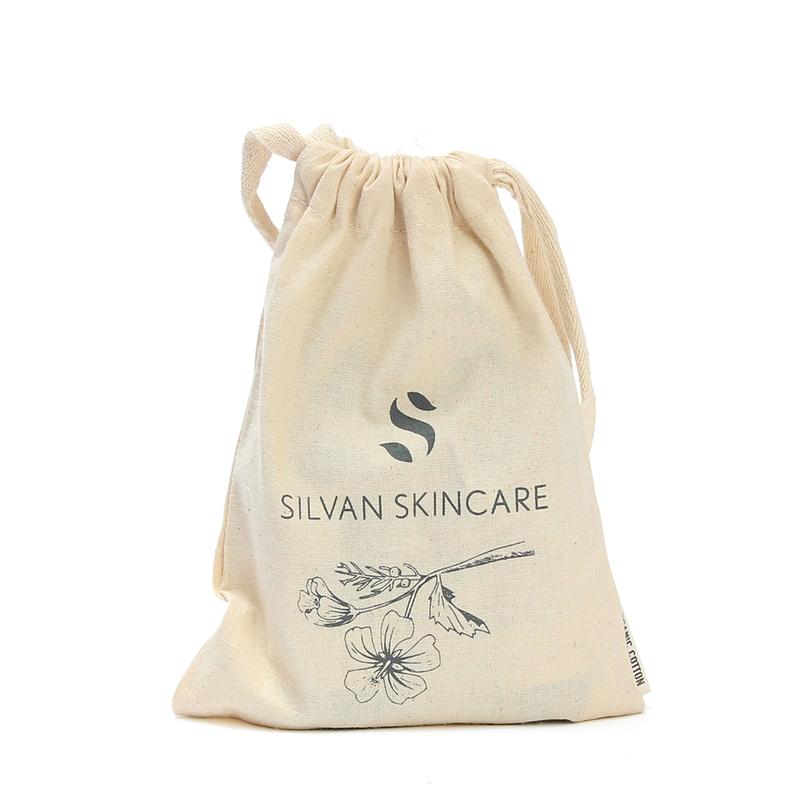 Silvan Skincare organic cotton gift bag with grey silvan skincare logo on it and an etching of a flower stem laid on its side