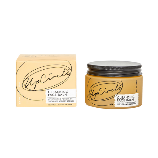 UpCircle Cleansing Face Balm. Sustainable skincare. The orange glass jar containing the balm is sitting next to the branded orange box it comes in.