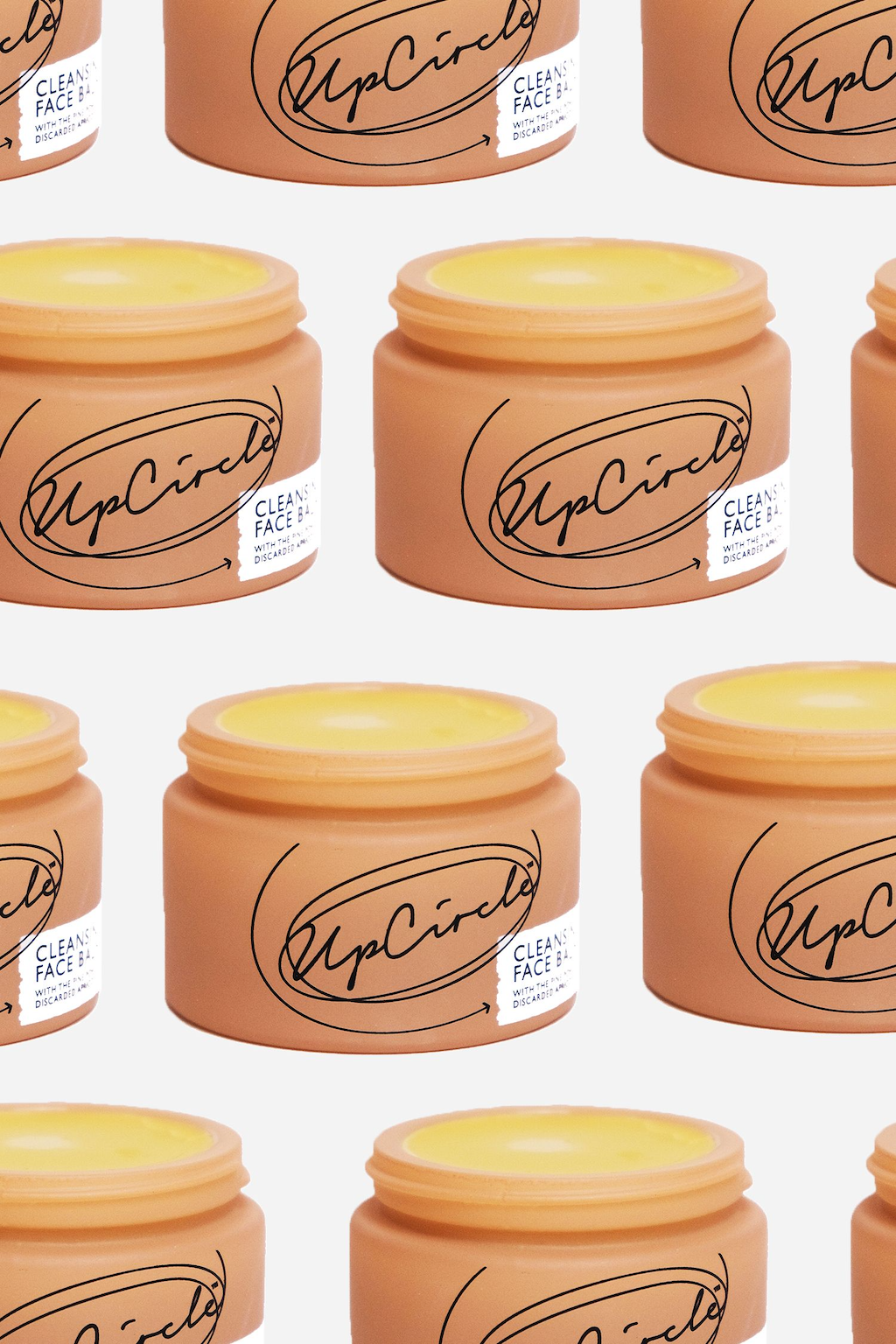UpCircle Cleansing Face Balm. Sustainable skincare. The orange glass jar is open and photo collaged into a repeating pattern