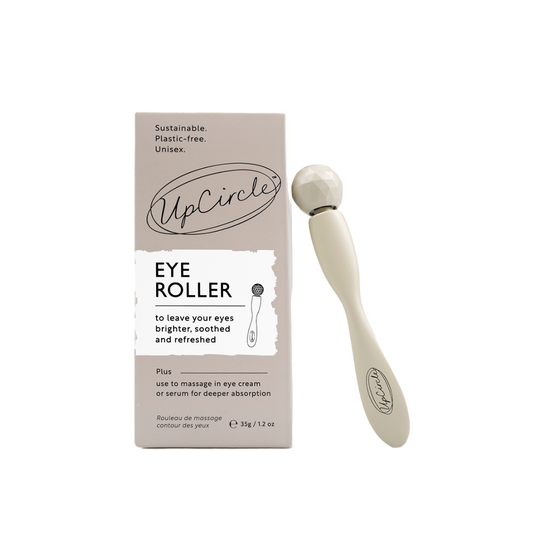 Upcircle eye roller tool on a white background. On the left you can see the box for the eye roller tool which reads 'sustainable, plastic free, unisex