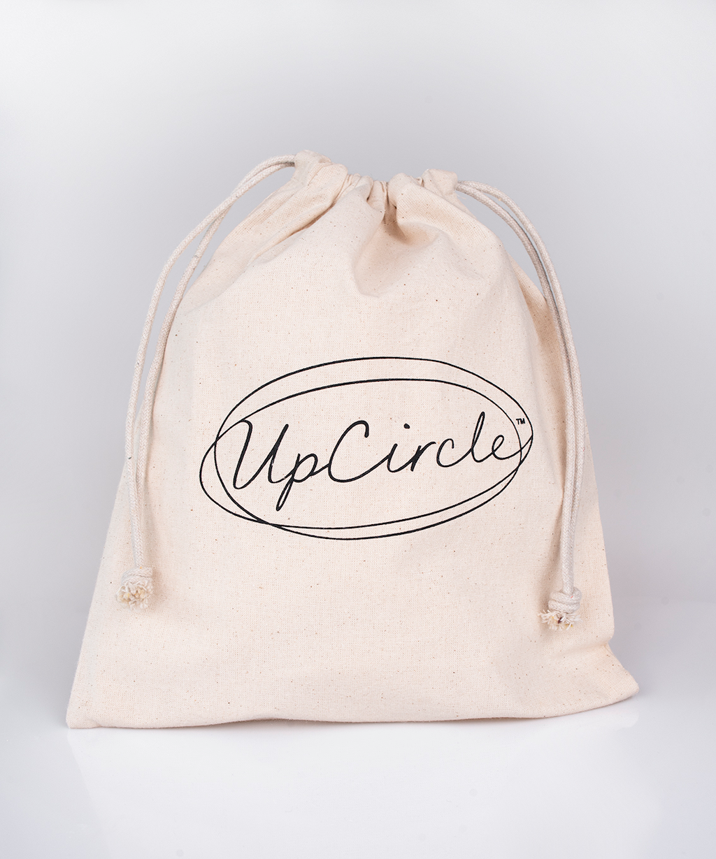 white linen bag with a drawstring which features the upcircle logo in a scrolling black font.