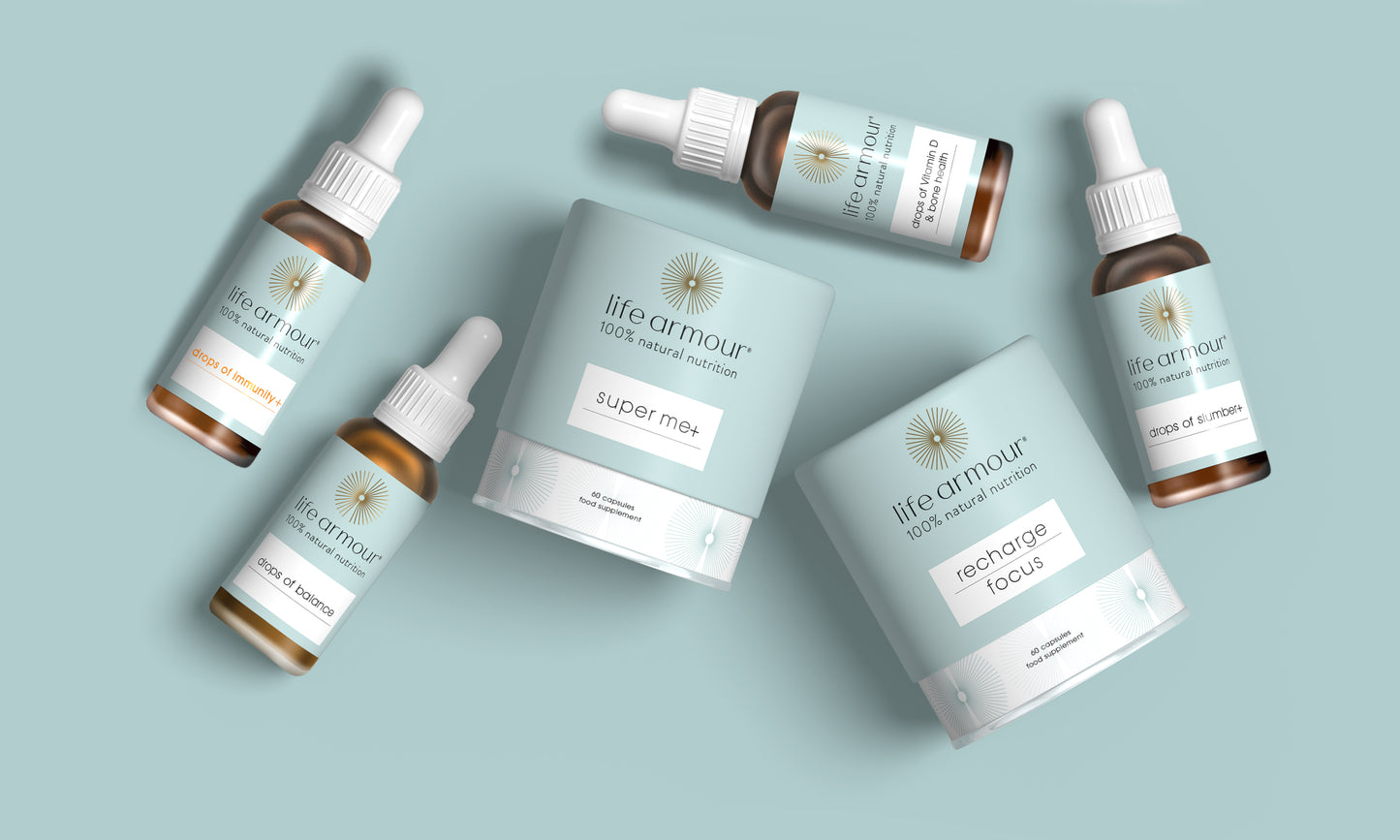 Overhead view of several Life Armour branded health and wellness products. This includes dropper bottles, jars, and a cylindrical package, all in soft pastel colors with minimalist design. The products are arranged on a light background.