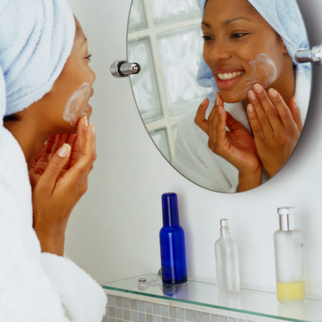 Woman putting facial moisturiser with natural, hydrating ingredients.