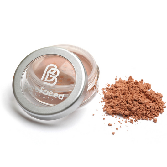 A small round pot of mineral bronzer, with a swatch of the powder next to it showing a warm/light shade of bronzer - a very subtle light bronzer for fair skin