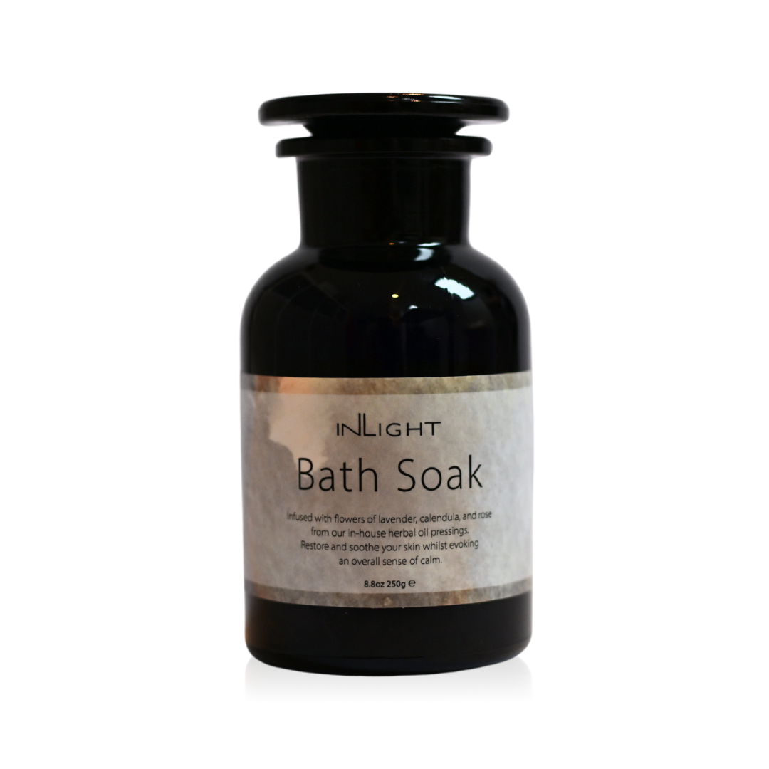 Black bottle of 'Bath Soak' with a label on a white background