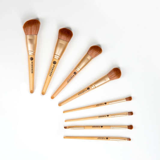 flat lay of Bomonde 8 piece brush set, fanned out across a white background from biggest to smallest, top to bottom