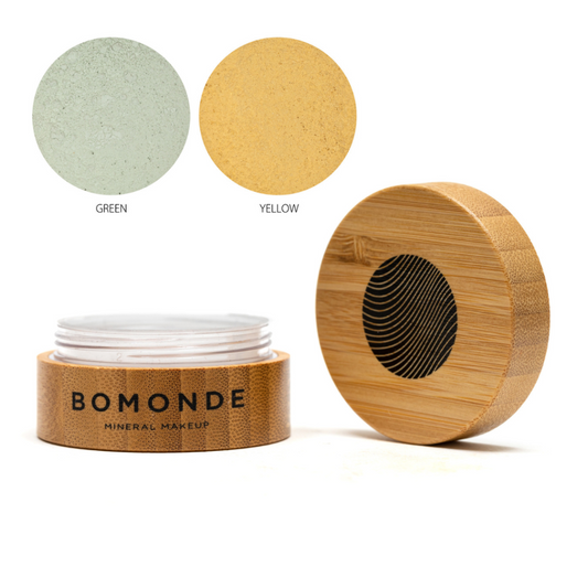 A round bamboo pot of Bomonde Loose mineral colour corrector, lid unscrewed and placed upright next to the pot - two swatches in the top right corner in shades green and yellow