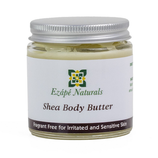 Shea body butter which is handmade by ezape naturals is photographed on a white background. the body cream comes in a clear glass jar with a silver aluminium lid. the label is white with a brown coloured band along the bottom and reads 'ezape naturals shea body butter fragrant free for irritated and sensitive skin’