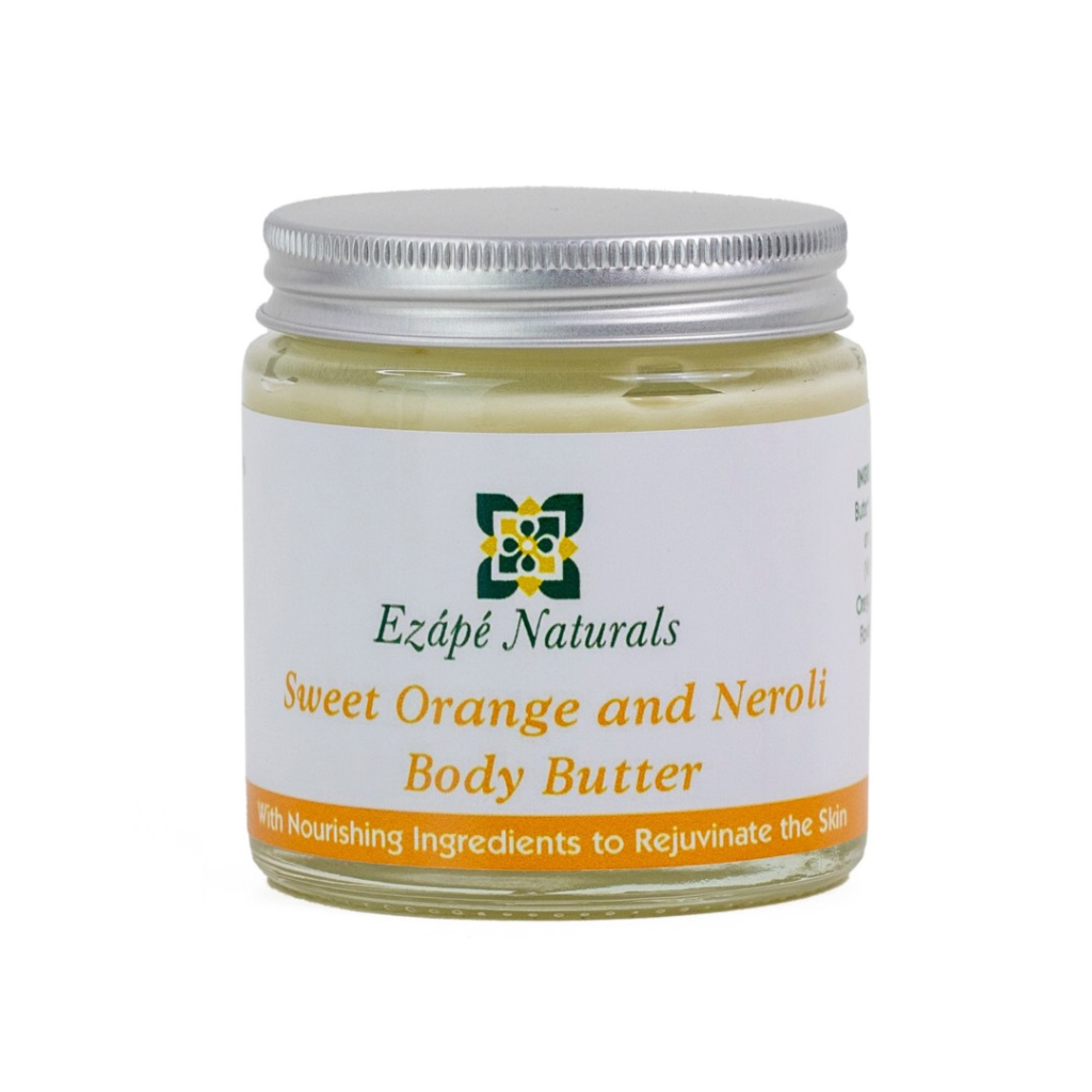 Sweet orange & Neroli body butter which is handmade by ezape naturals is photographed on a white background. the body cream comes in a clear glass jar with a silver aluminium lid. the label is white with an orange coloured band along the bottom and reads 'ezape naturals Sweet orange & Neroli body butter with nourishing ingredients to restore the skin'