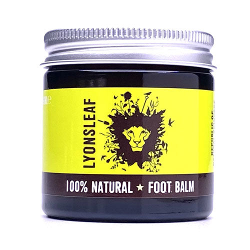 lyonsleaf foot balm photographed on a white background. the balm comes in an amber glass jar with silver aluminium lid and a chartreuse label with the lyonsleaf name and lions mane with flowers coming out of it logo. the brown banner label underneath reads 100% natural foot balm