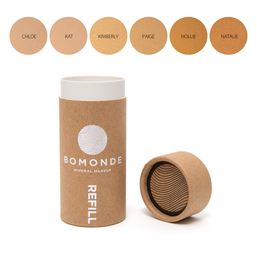 cylindrical cardboard packaging of Bomonde mineral foundation refill. Lid placed next to it. six swatches displayed above the product from left to right; Chloe, Kat, Kimberly, Paige, Hollie and Natalie.
