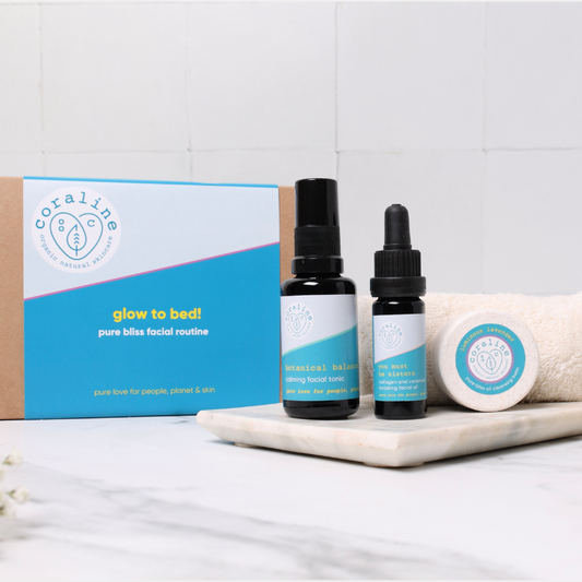 3 step night time cleanse, tone, moisturise natural skincare routine on top of a white tile with a brown kraft gift box with blue sleeve in the background