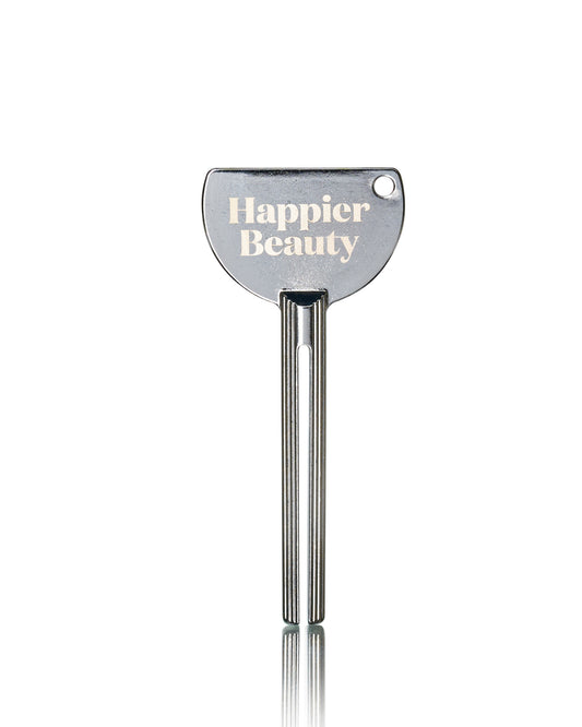 stainless steel tube roller/squeezer key with happier beauty logo on it