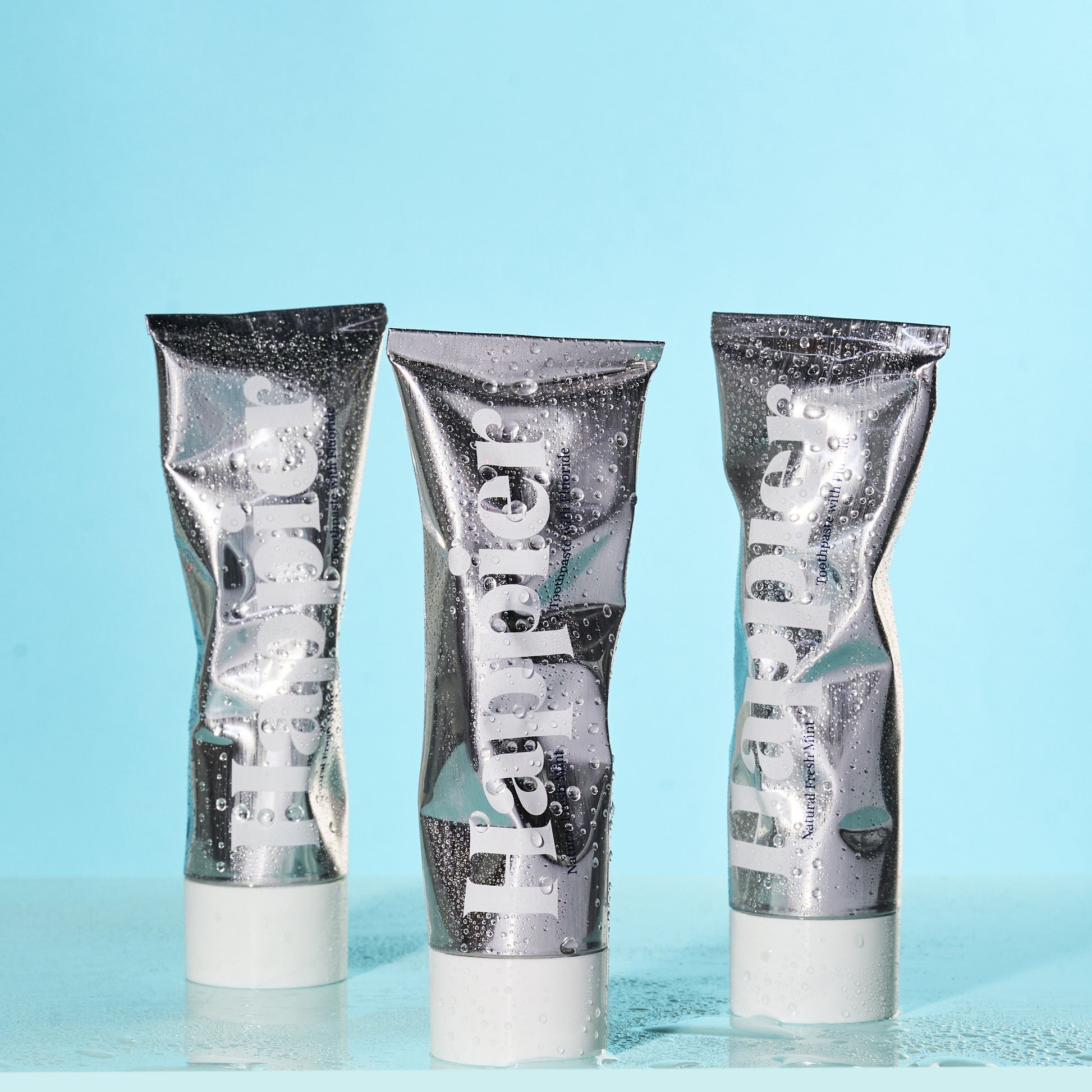 trio of happier beauty's natural whitening toothpaste in aluminium tube