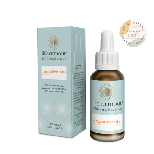 The image shows a bottle of "Life Armour Drops of Immunity+" with a dropper top, positioned next to its light blue and white box packaging. The product lists the 100% natural ingredients and vitamins. An award badge for 2021 wellness awards is visible in the background.