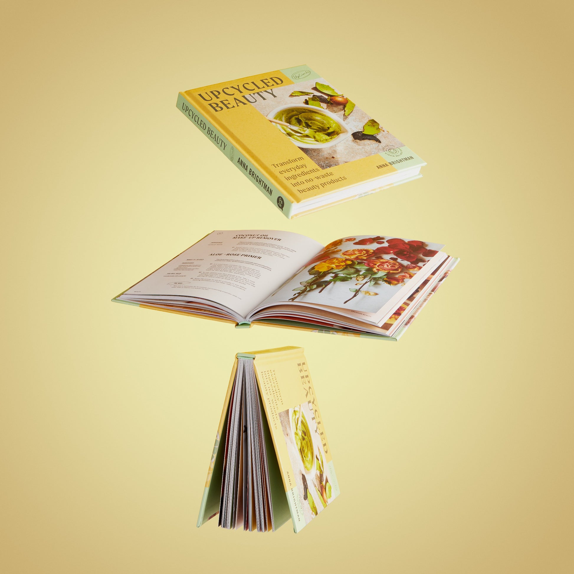 photo of different angles of upcircle's skincare recipe book as if suspended in the air on a yellow background