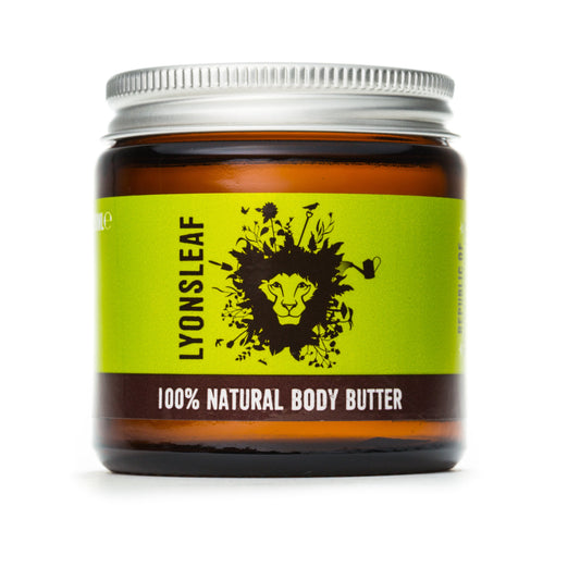 photo shows a brown glass jar with aluminium lid on a white background. the jar is filled with creamy body butter made by 100% natural skincare brand lyonsleaf. The label on the jar is green and features a lions mane