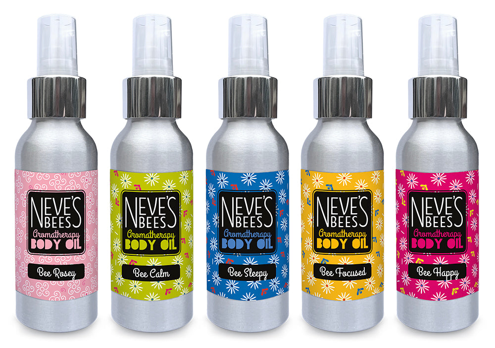 5 natural, handmade body oils in aluminium bottles with pump lids lined up together