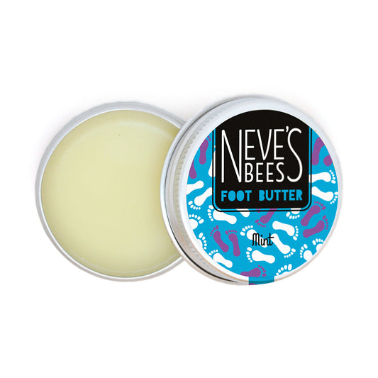 100% natural foot butter from neve's bees photographed on a white background. the foot butter comes in an aluminium tin which is seen here opened with the lid balanced on top. you can see the light cream coloured texture of the balm within. the lid has a turquoise logo which reads 'neve's beens foot butter, mint' and behind you can see white and purple outlines of feet