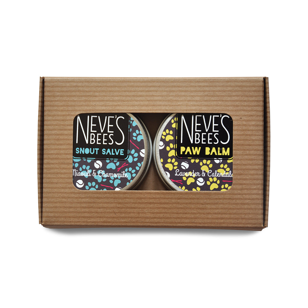 a duo of aluminium tins in a white karft window box. one tin is a paw balm for dogs and the other is a snout balm for dogs. Both are made with organic beeswax by neve's bees in oxfordshire