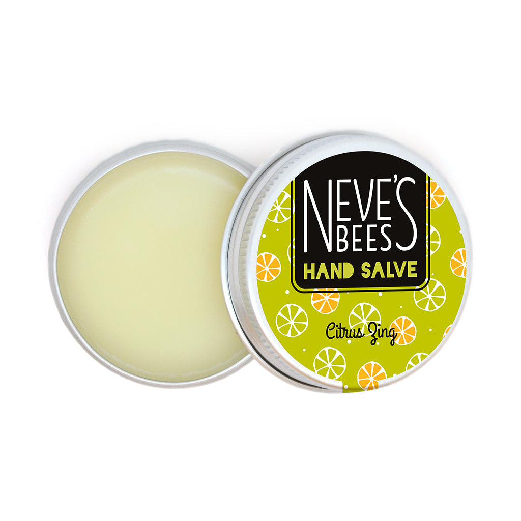 photo of neve's bees hand salve on a white background. the hand salve comes in an aluminium tin with a lime green label on it that reads 'neve's bees hand salve citrus zing' there are graphics of citrus fruit segments in the background of the label. the tin is open and you can see the creamy coloured balm inside