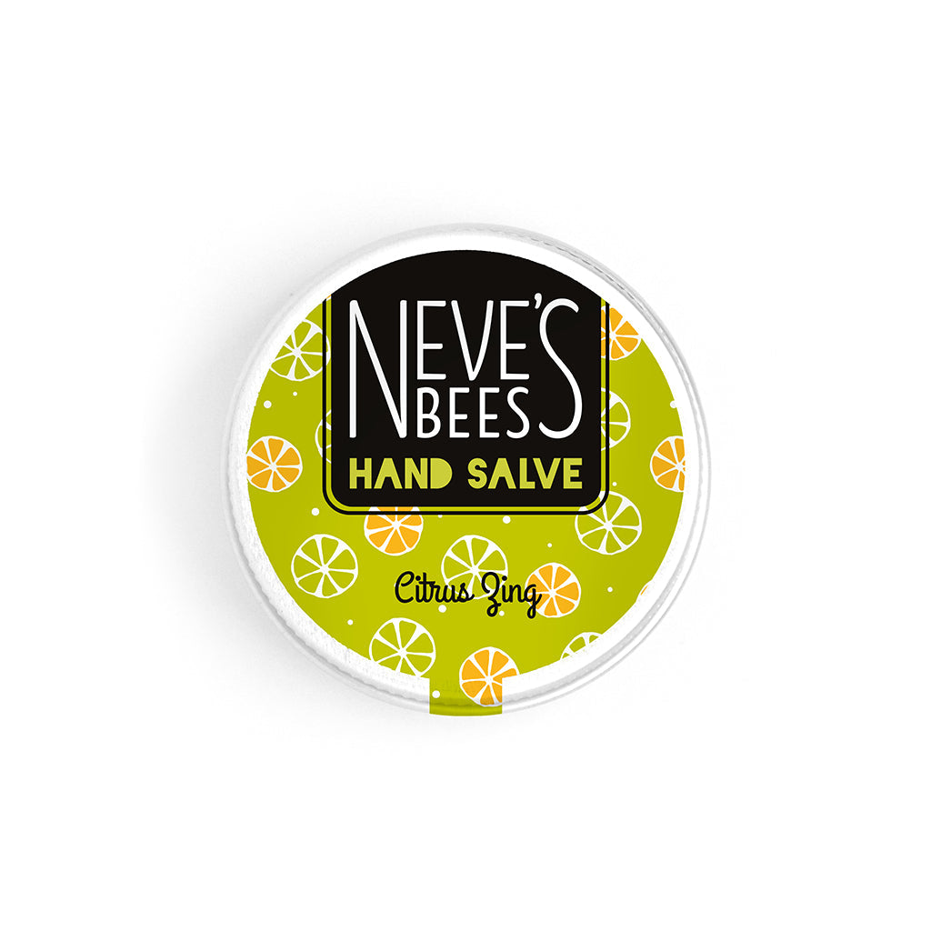 photo of neve's bees hand salve on a white background. the hand salve comes in an aluminium tin with a lime green label on it that reads 'neve's bees hand salve citrus zing' there are graphics of citrus fruit slices in the background of the label. 