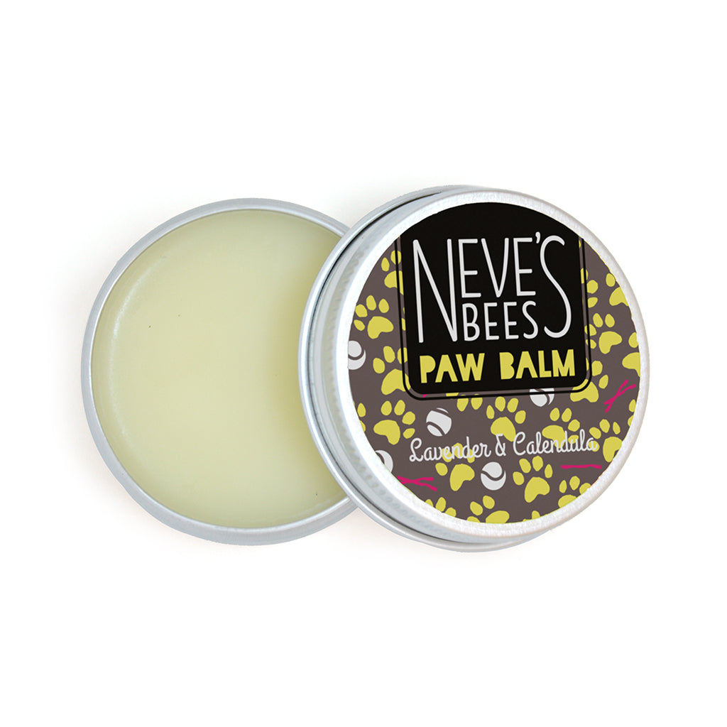 an open aluminium tin of dog paw balm. You can see the white creamy texture of the salve. The tin lid has a grey, yellow and white sticker on it with the neve's bees logo and paw prints, sticks and balls on it