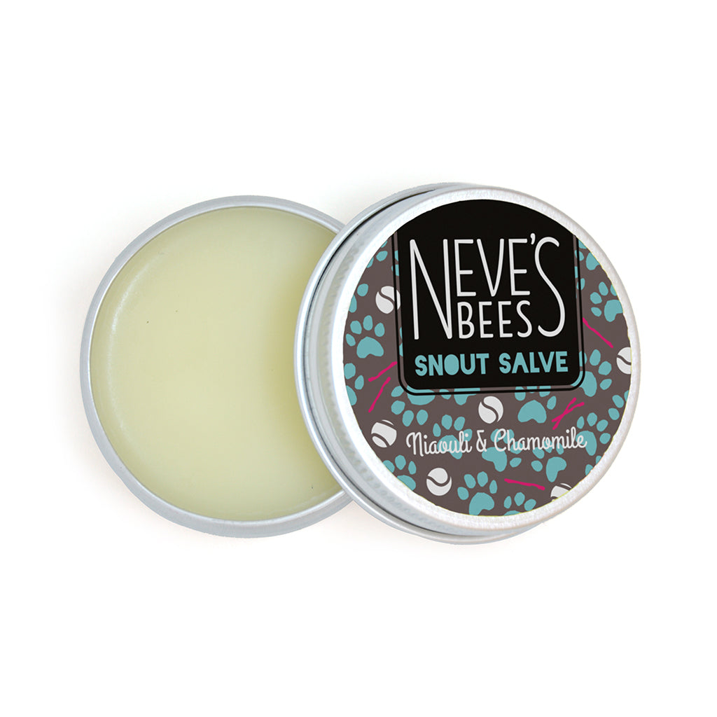 an open aluminium tin of dog snout salve. You can see the white creamy texture of the salve. The tin lid has a grey, turquoise and white sticker on it with the neve's bees logo and paw prints, sticks and balls on it