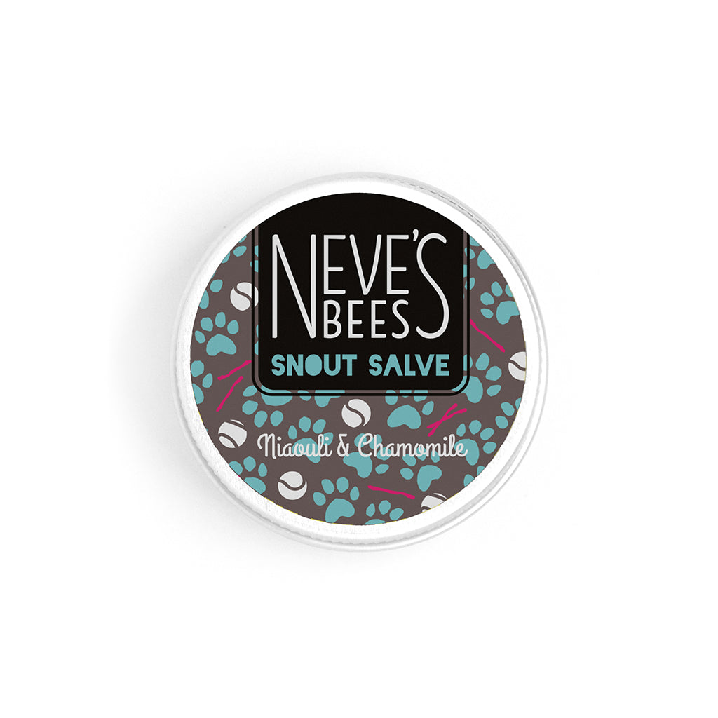 an open aluminium tin of dog snout salve. You can see the white creamy texture of the salve. The tin lid has a grey, turquoise and white sticker on it with the neve's bees logo and paw prints, sticks and balls on it