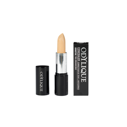 A single tube of the Odylique Medium concealer with the cap removed, revealing a medium concealer shade, set against a plain white background.