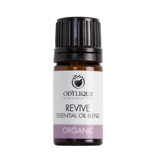 An amber glass dropper bottle of odylique revive essential oil blend 