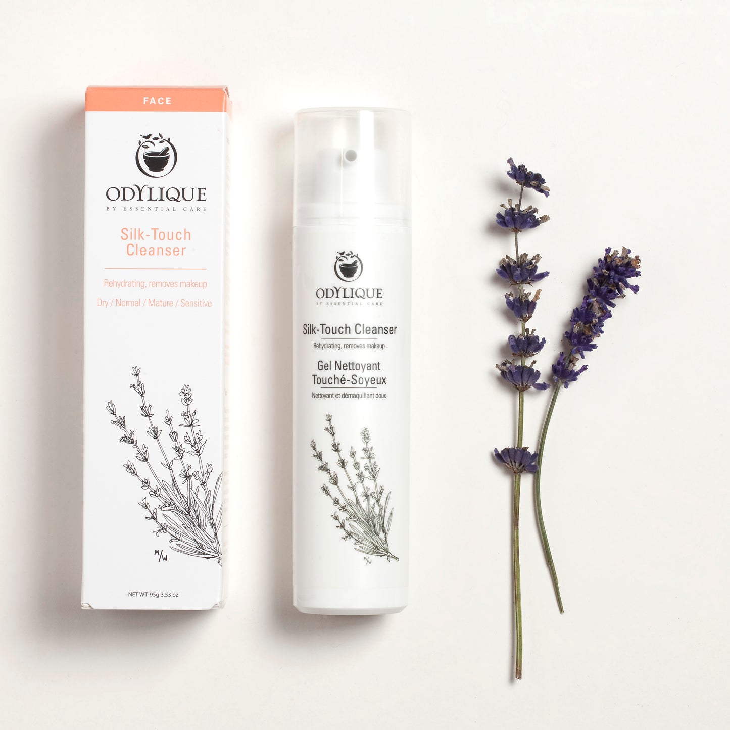 box and bottle of the odylique silk touch cleanser laid flat next to a frond of lavender which is in the formulation of this natural cleanser