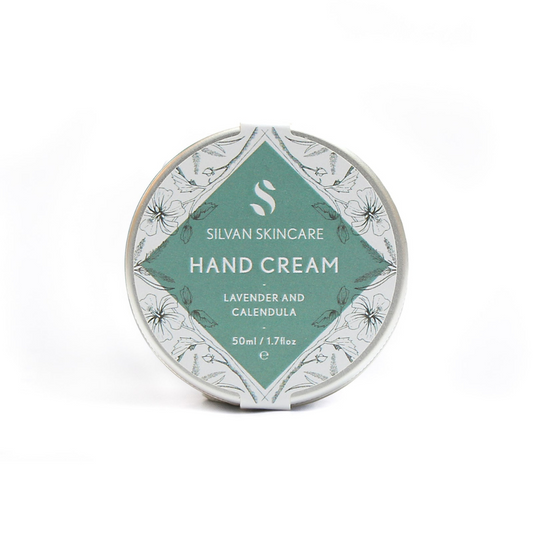 Lavender and calendula handcream photographed on a white background. the natural, vegan and cruelty free hand cream is shown in a silver coloured tin with a white and muted turquoise label on it that reads silvan skincare hand cream lavender and calendula