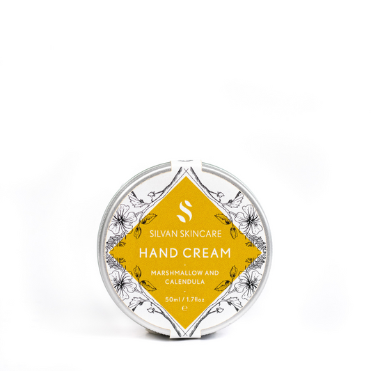 silvan skincare hand cream on a white background. the hand cream is in an aluminium pot with a white and yellow labels which reads: silvan skincare hand cream marshmallow and calendula 50ml