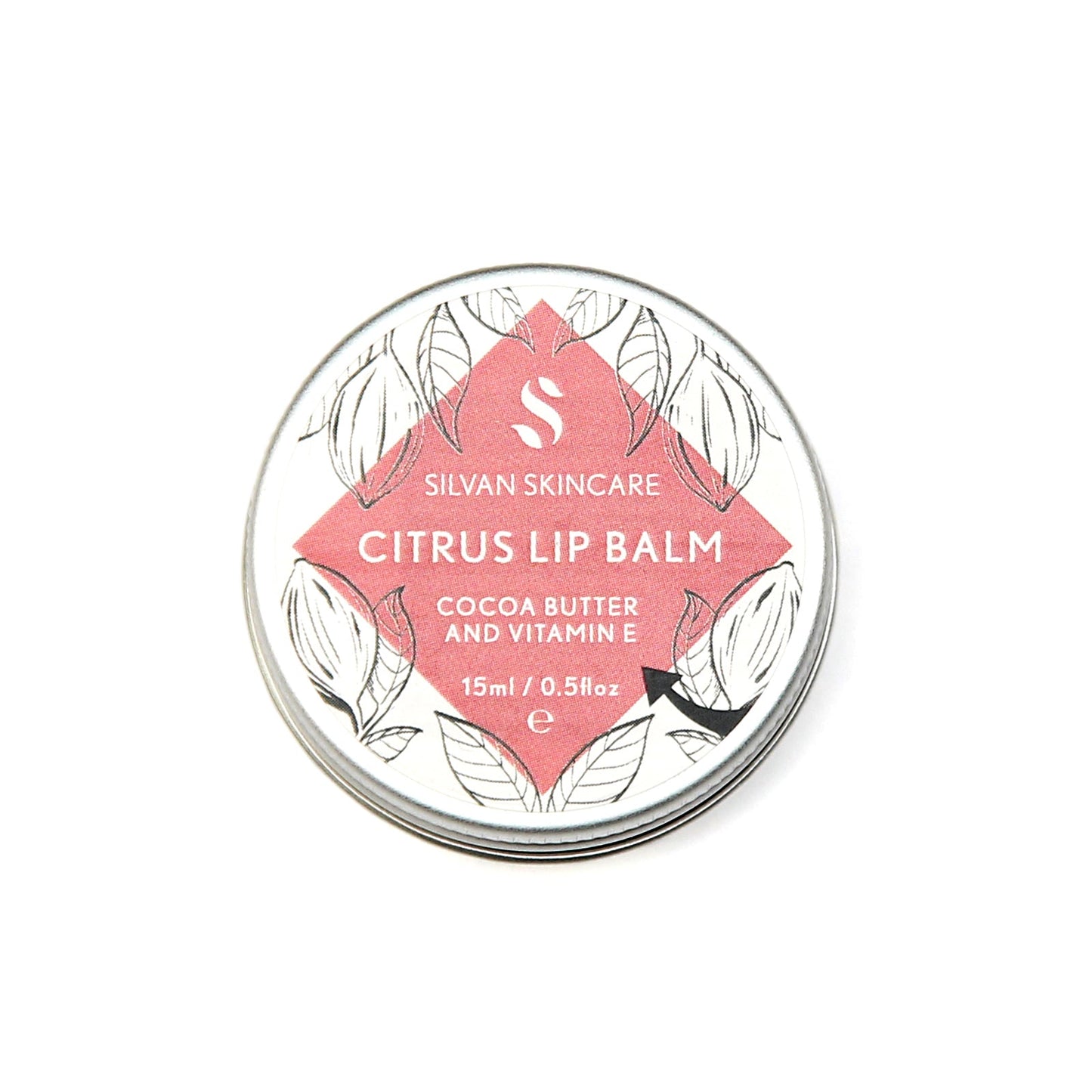 Single aluminium tin of the Silvan Skincare citrus lip balm. The label is round and white with a central diamond in pink and botanical illustrations around it.