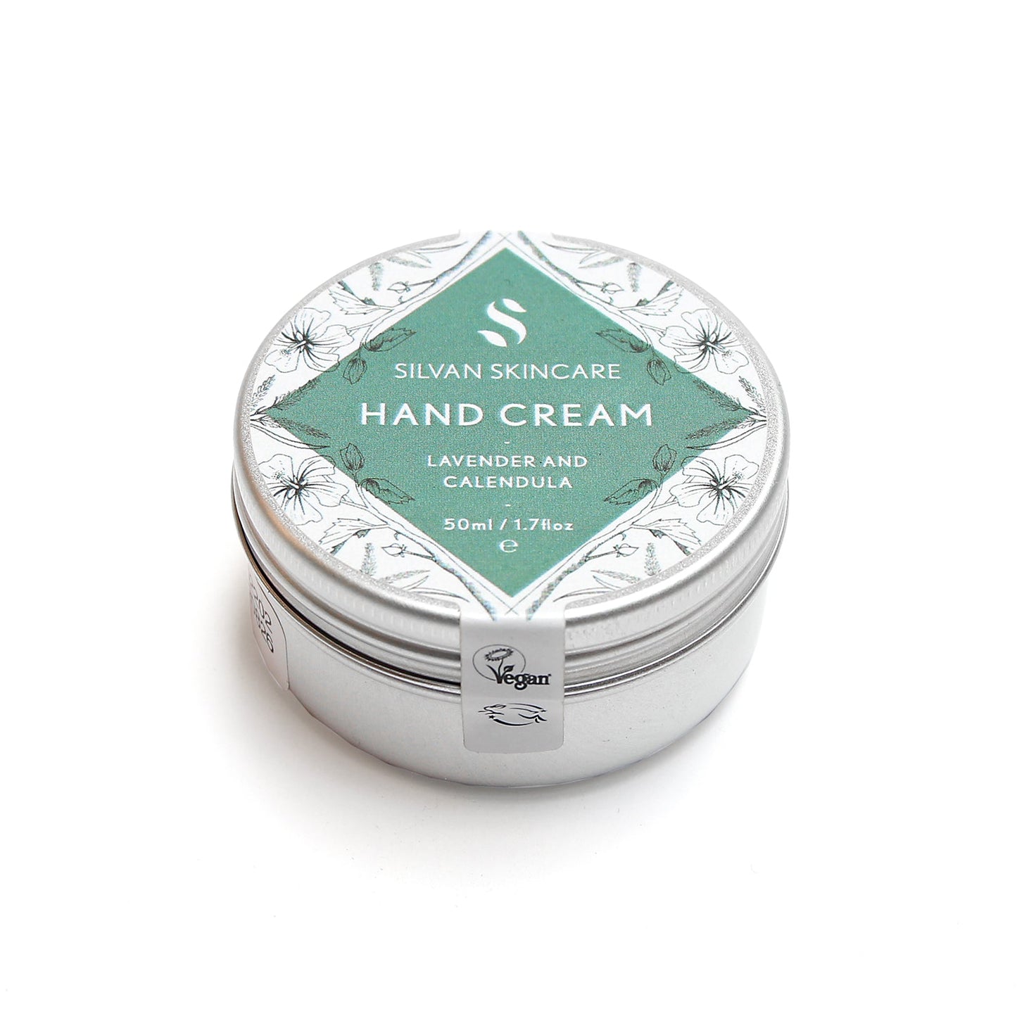 Lavender and calendula handcream photographed on a white background at a slight angle. the natural, vegan and cruelty free hand cream is shown in a silver coloured tin with a white and muted turquoise label on it that reads silvan skincare hand cream lavender and calendula