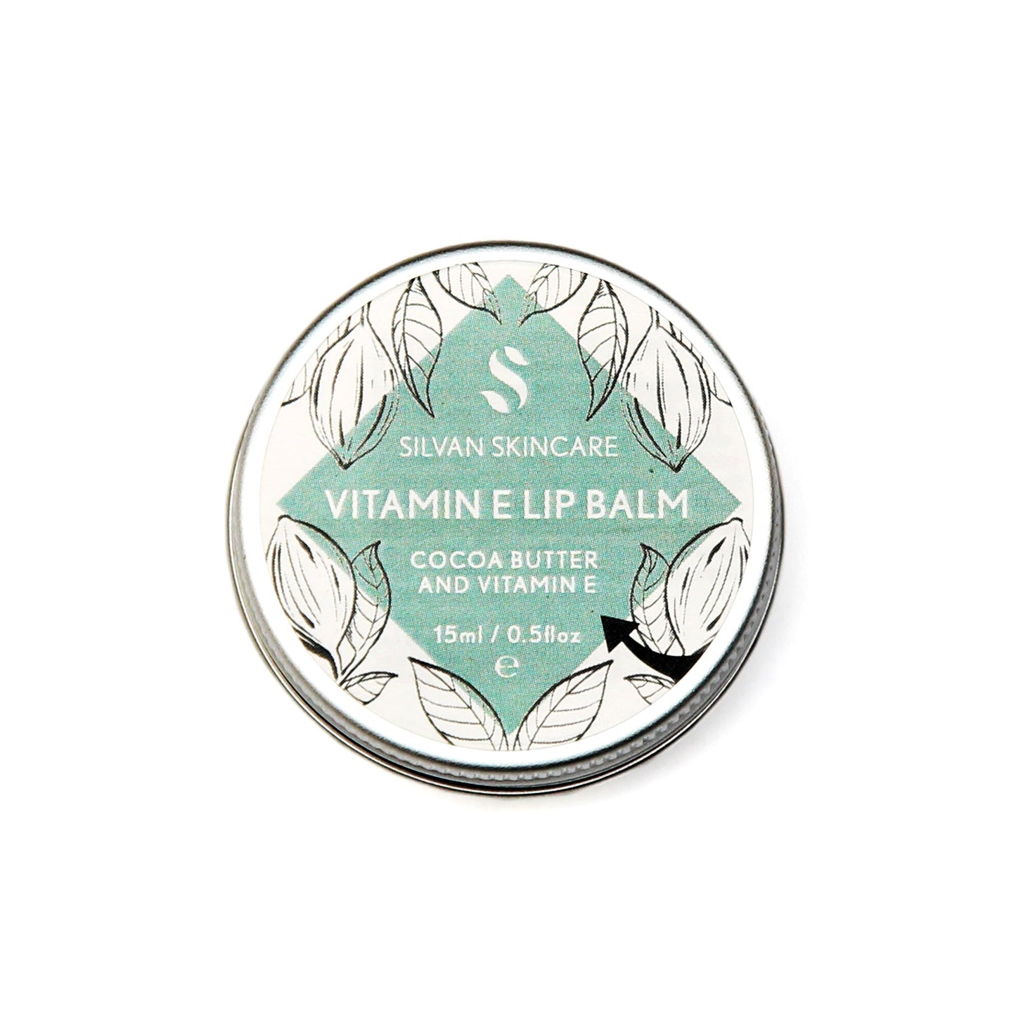 Single aluminium tin of the Silvan Skincare vitamin e lip balm. The label is round and white with a central diamond in blue and botanical illustrations around it.