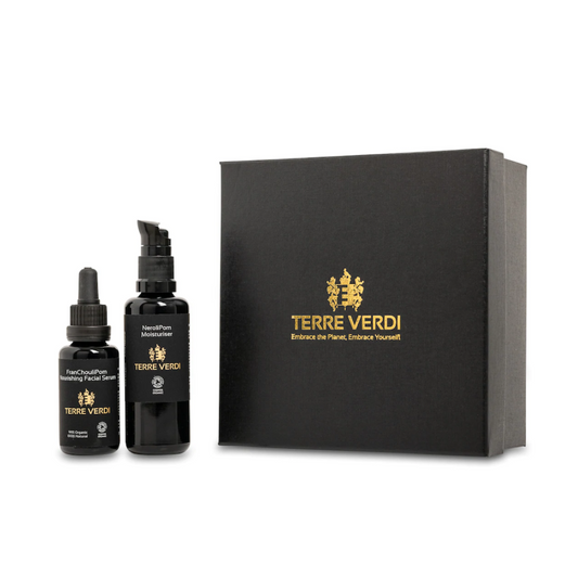 Terre Verdi Organic Gift Set for Face with Replenishing Face Serum. Natural skincare gift set. All of the products are in black bottles and stand next to a luxury black box embossed in gold with the Terre Verdi logo.