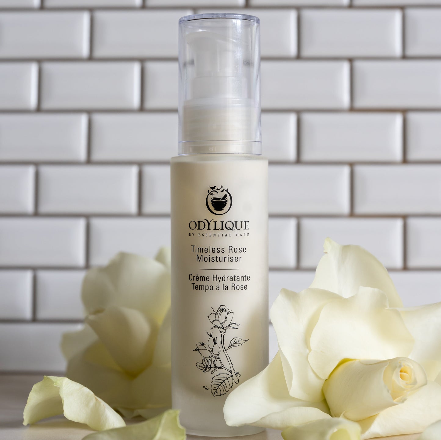 organic rose moisturiser with rose petals on tiled background