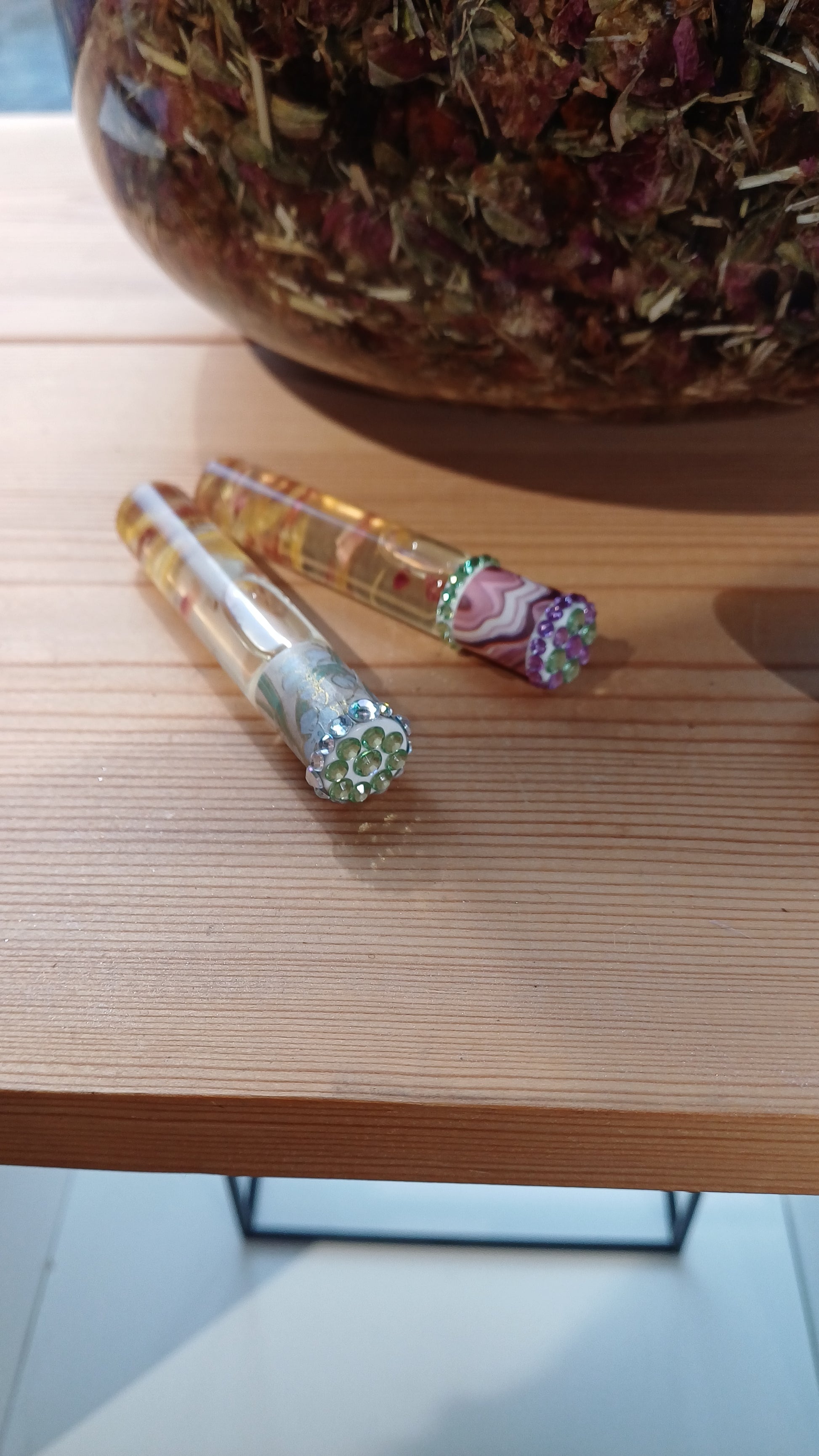 examples of decorated aromatherapy oils with crystal stickers