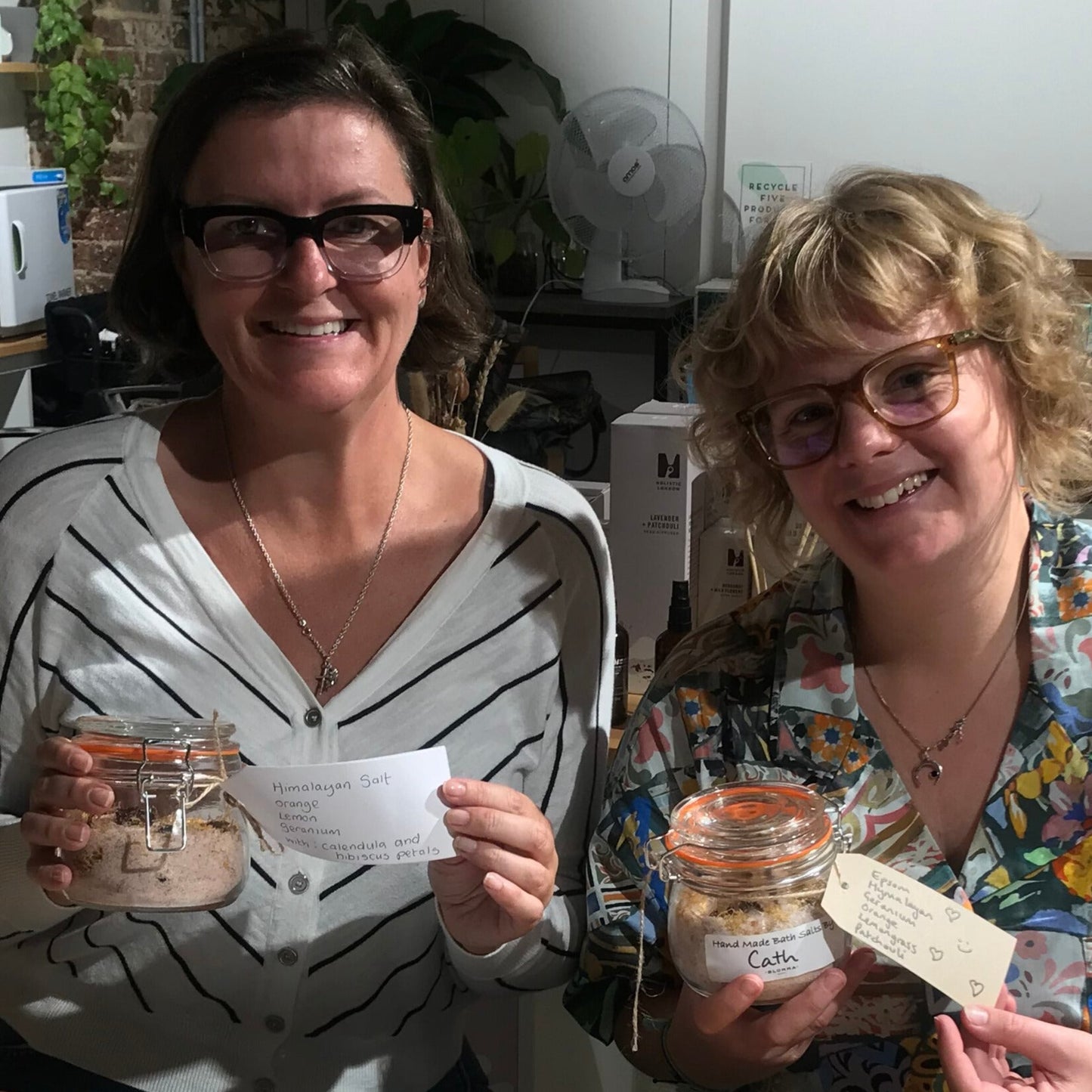 two women showing off their bath salts they have made at a blomma beauty class in london