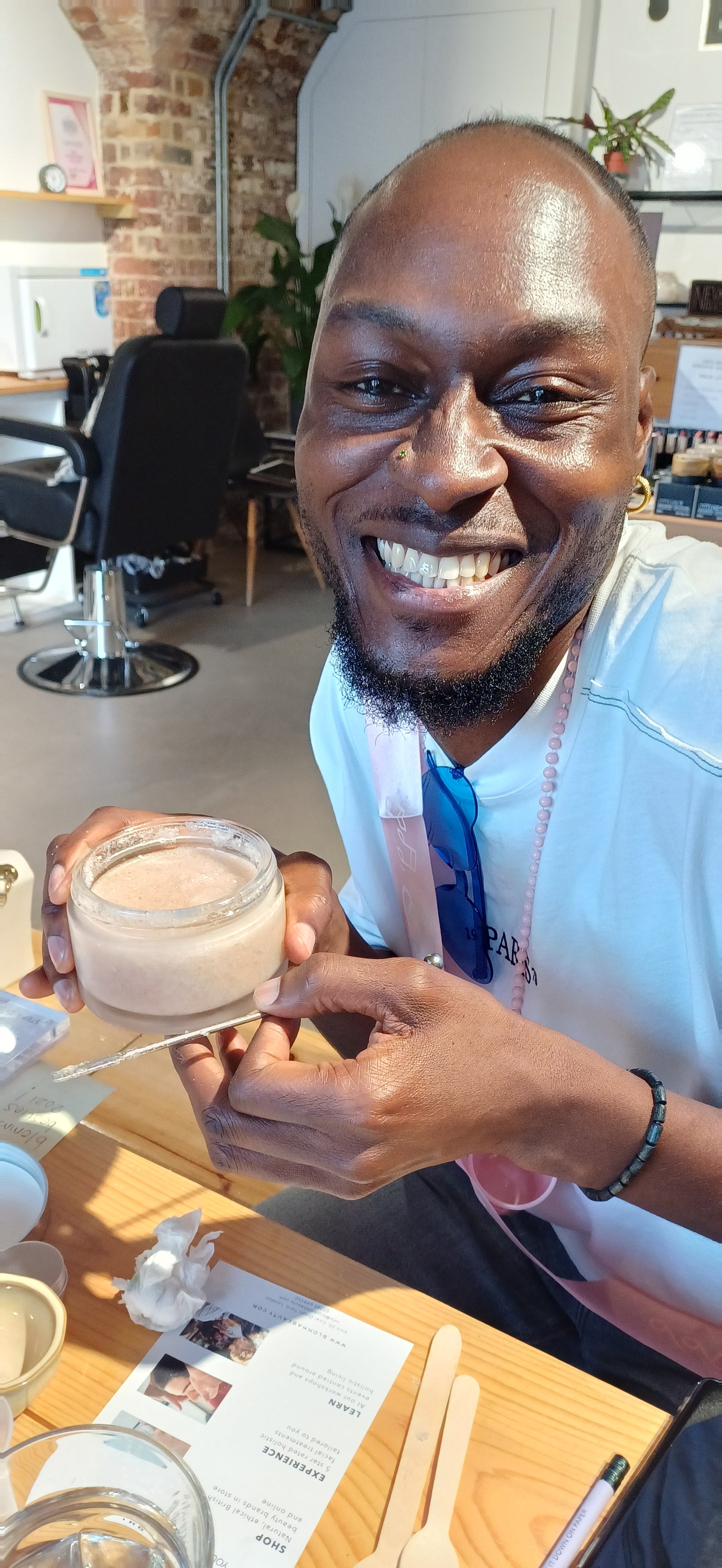 smiling man showing off his hand made body scrub