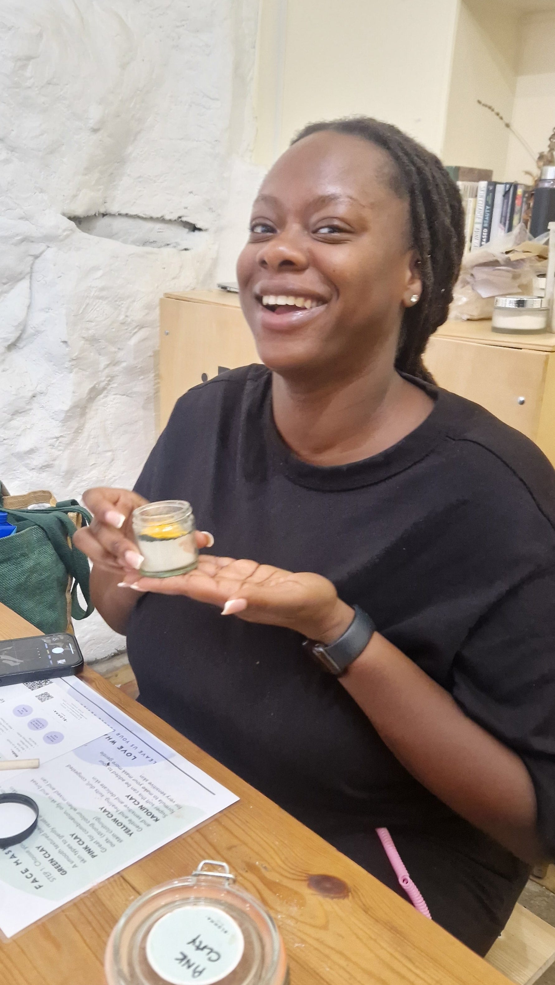 person holding their handmade clay face mask